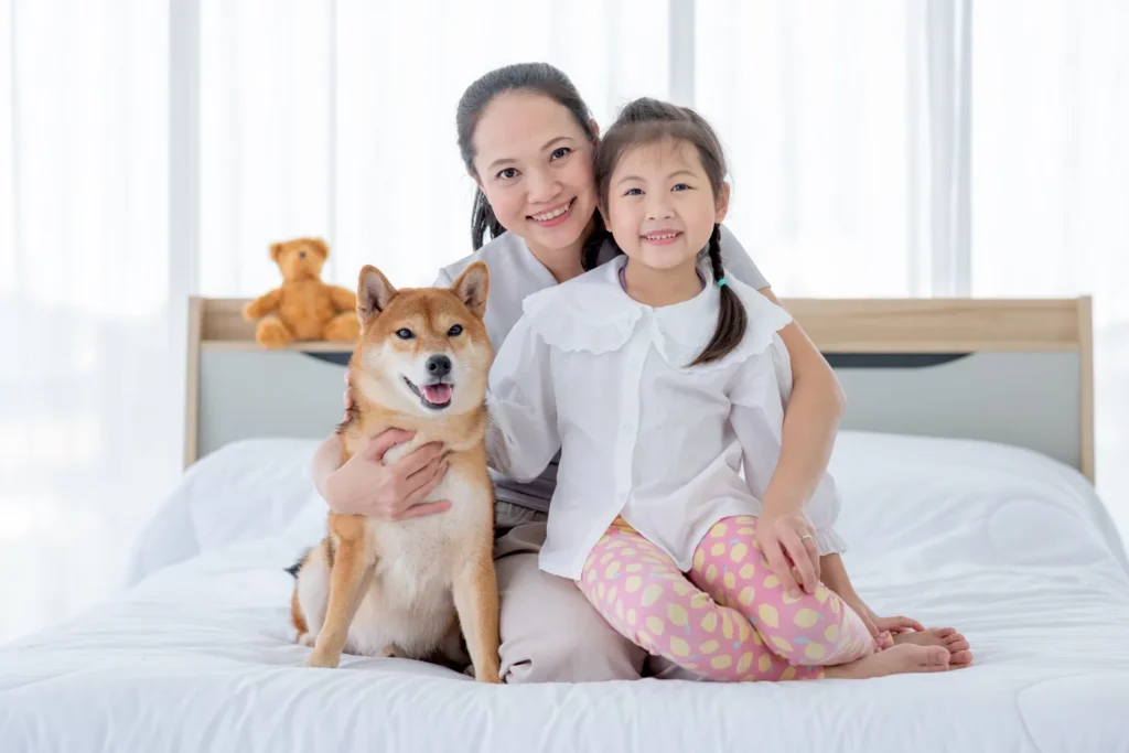 A family with their pet dog on a freshly cleaned mattress in Singapore